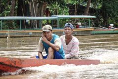 Local Lao fisher men riding their longtail boats on the Mekong, 4000 Islands